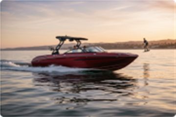 Wake boat cruising at golden hour