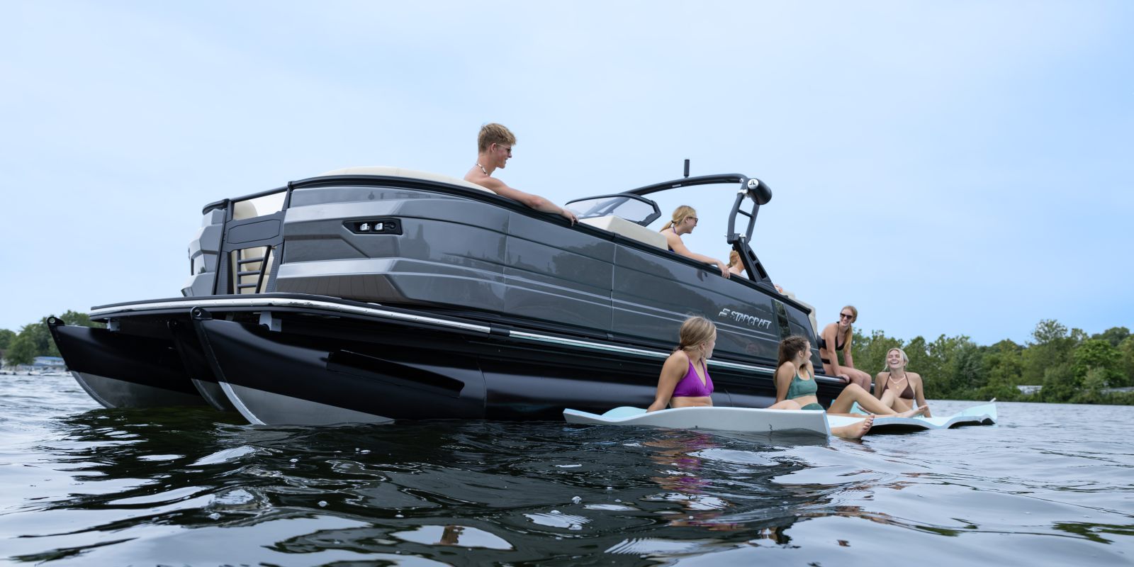 Pontoon boat anchored off a sandbar