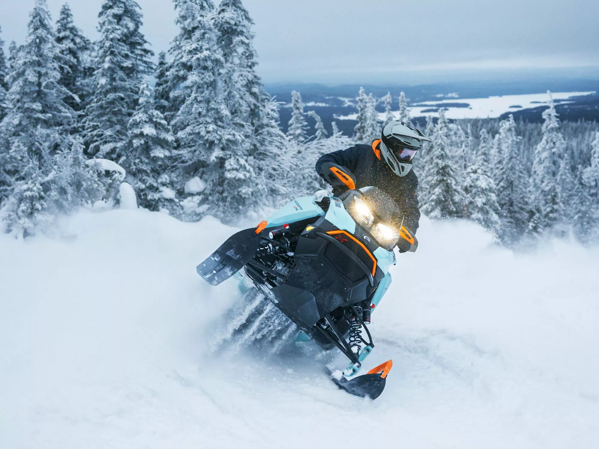 Ski-Doo snowmobile riding through fresh powder