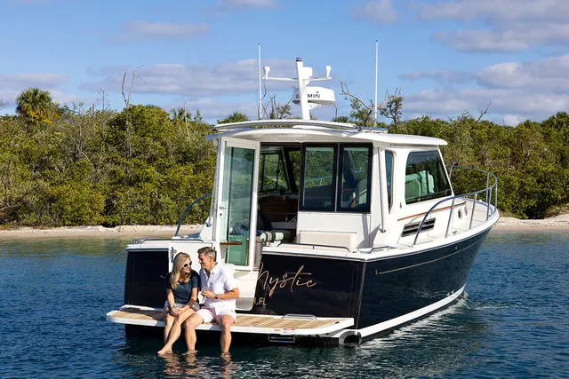 Man and woman couple sitting on a Back Cove Yacht anchored in the water