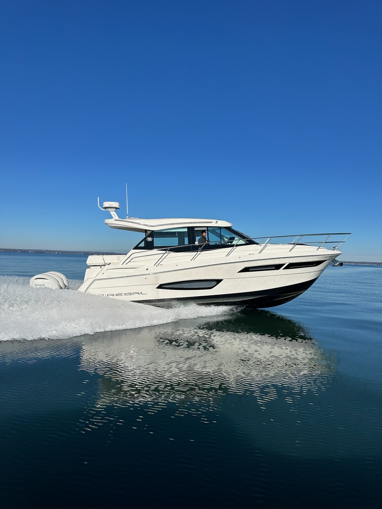 Regal boat speeding on open water