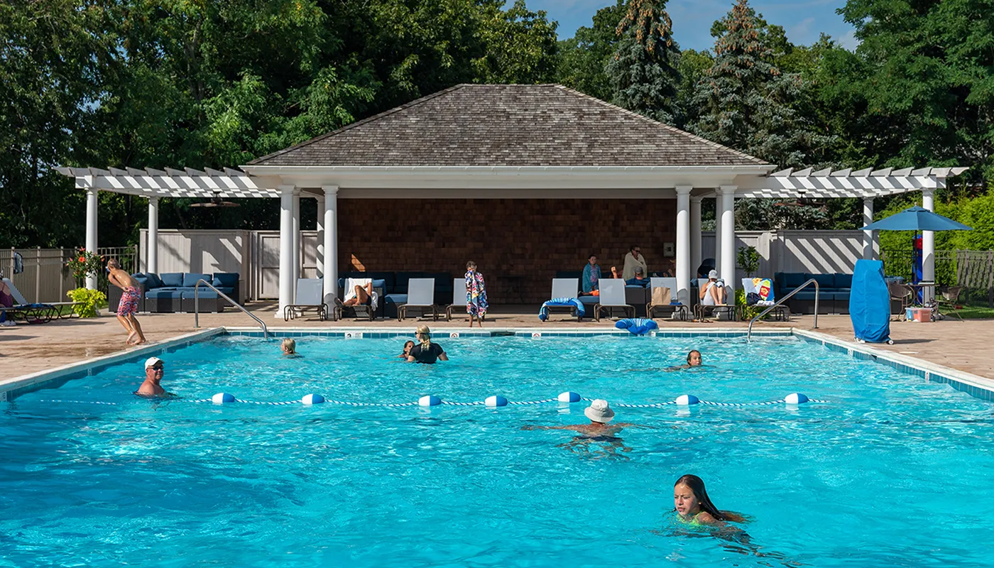 Members enjoying the exclusive pool club at Strong's Water Club with waterfront views