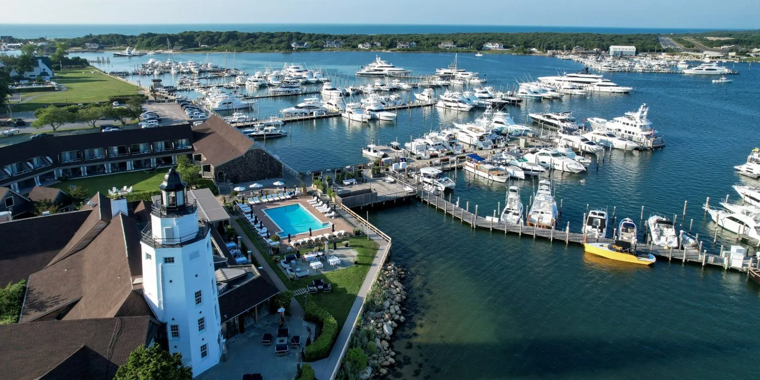 Aerial view of Montauk Yacht Club marina with docked boats and surrounding buildings