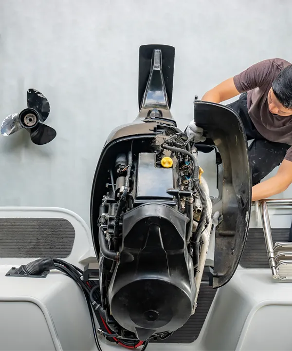 Technician servicing a wake boat at the Discovery Bay shop