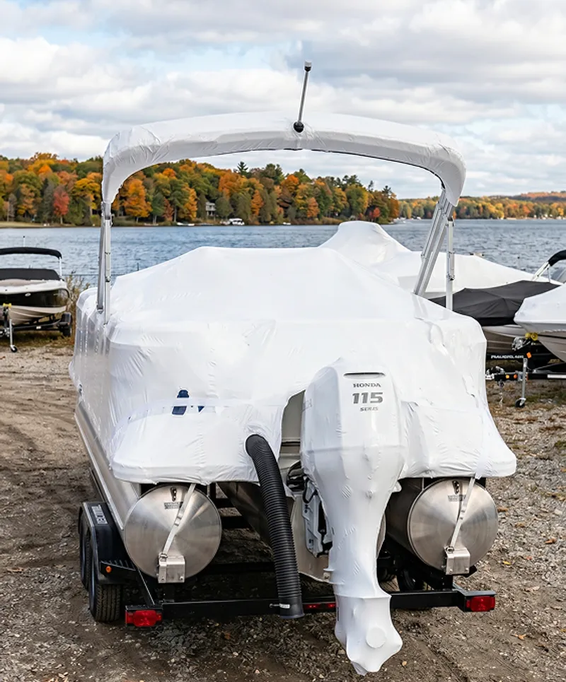 Inboard boat engine being winterized by a technician