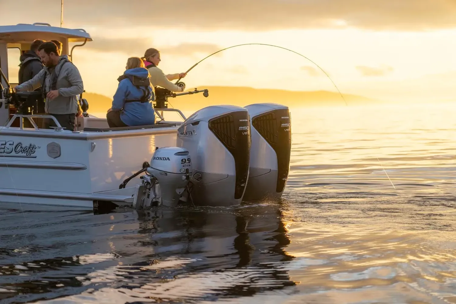 Honda outboard engine mounted on boat with water and scenery