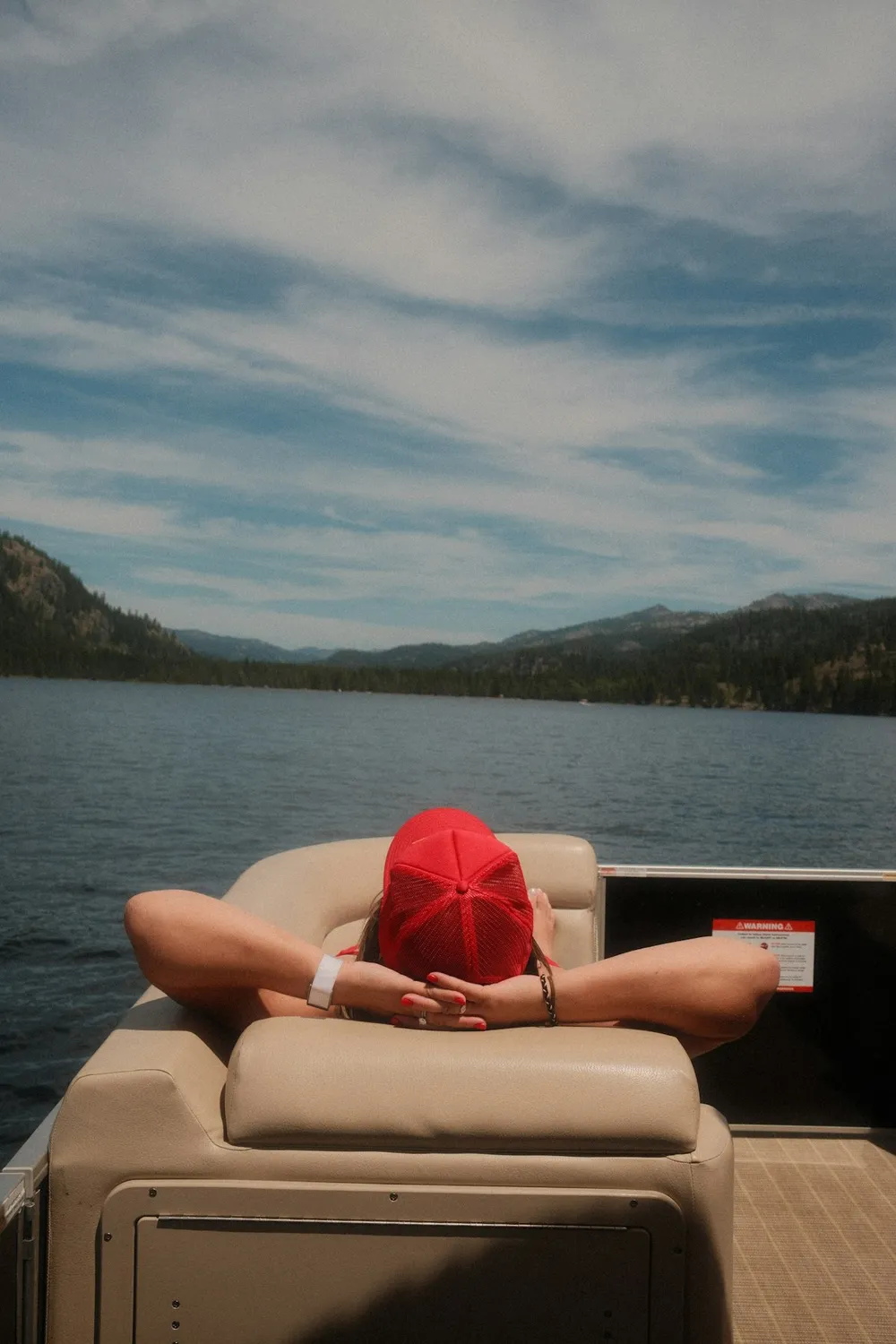 Boater relaxing on the bow of a boat on the water