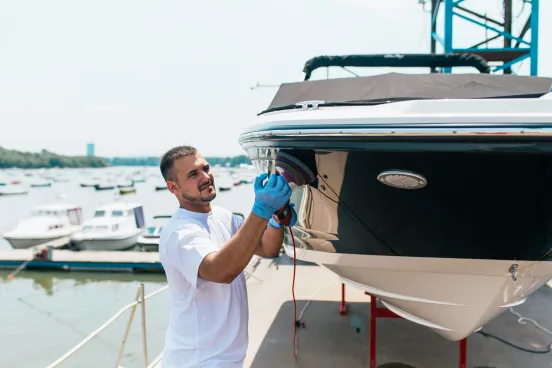 Marine service mechanic working on boat engine