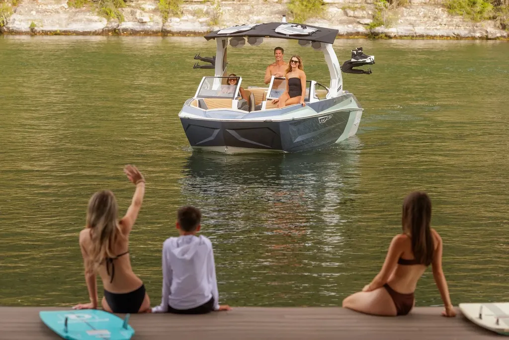 Family waving from the dock as the boat arrives