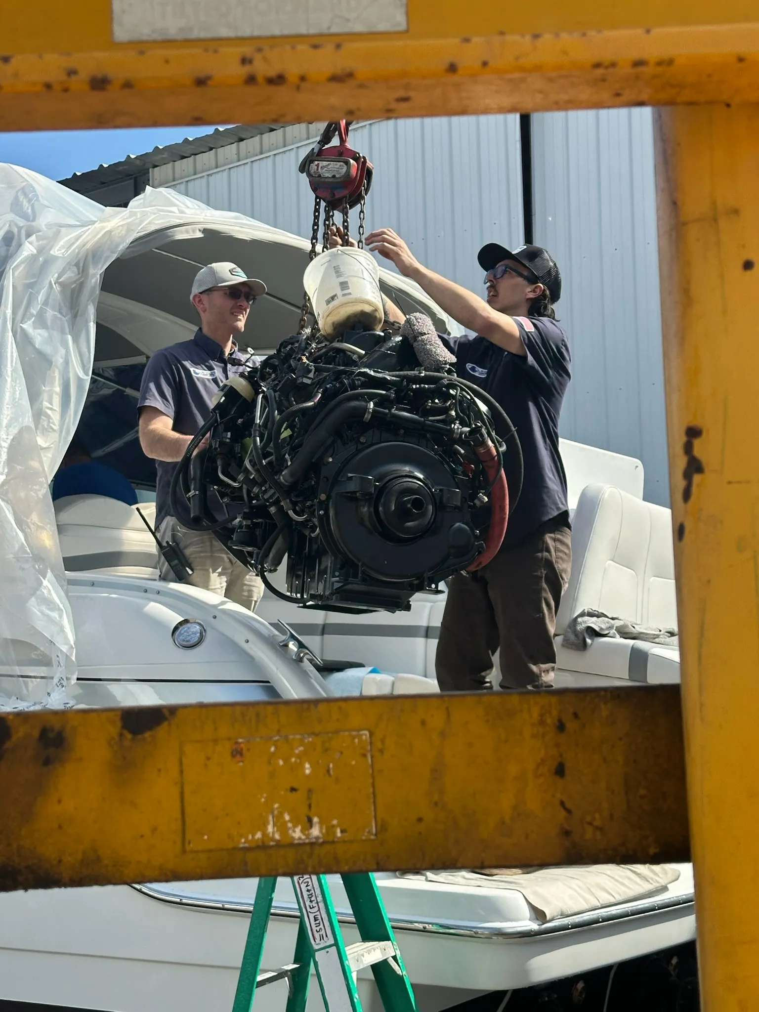 Factory-trained technicians working on a boat in the Petzold&rsquo;s Marine Center service bay