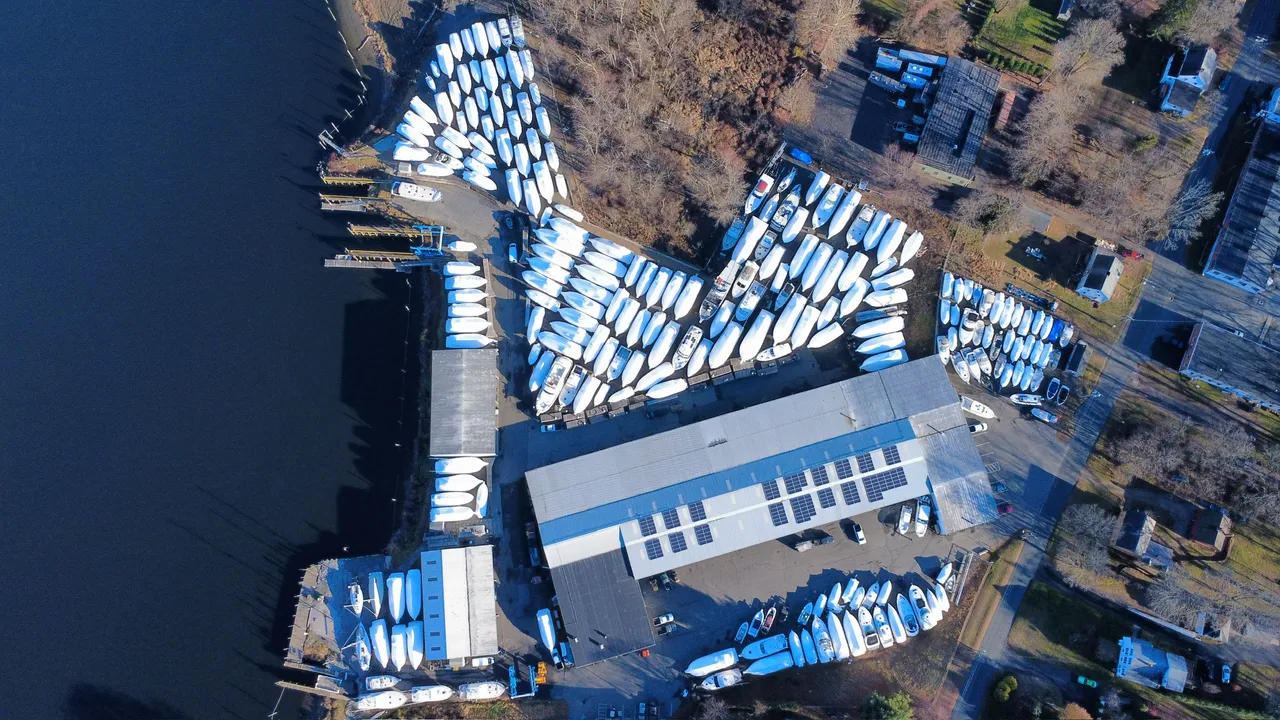 Boats blocked and shrink-wrapped in the outdoor winter storage yard at Petzold&rsquo;s Marine Center