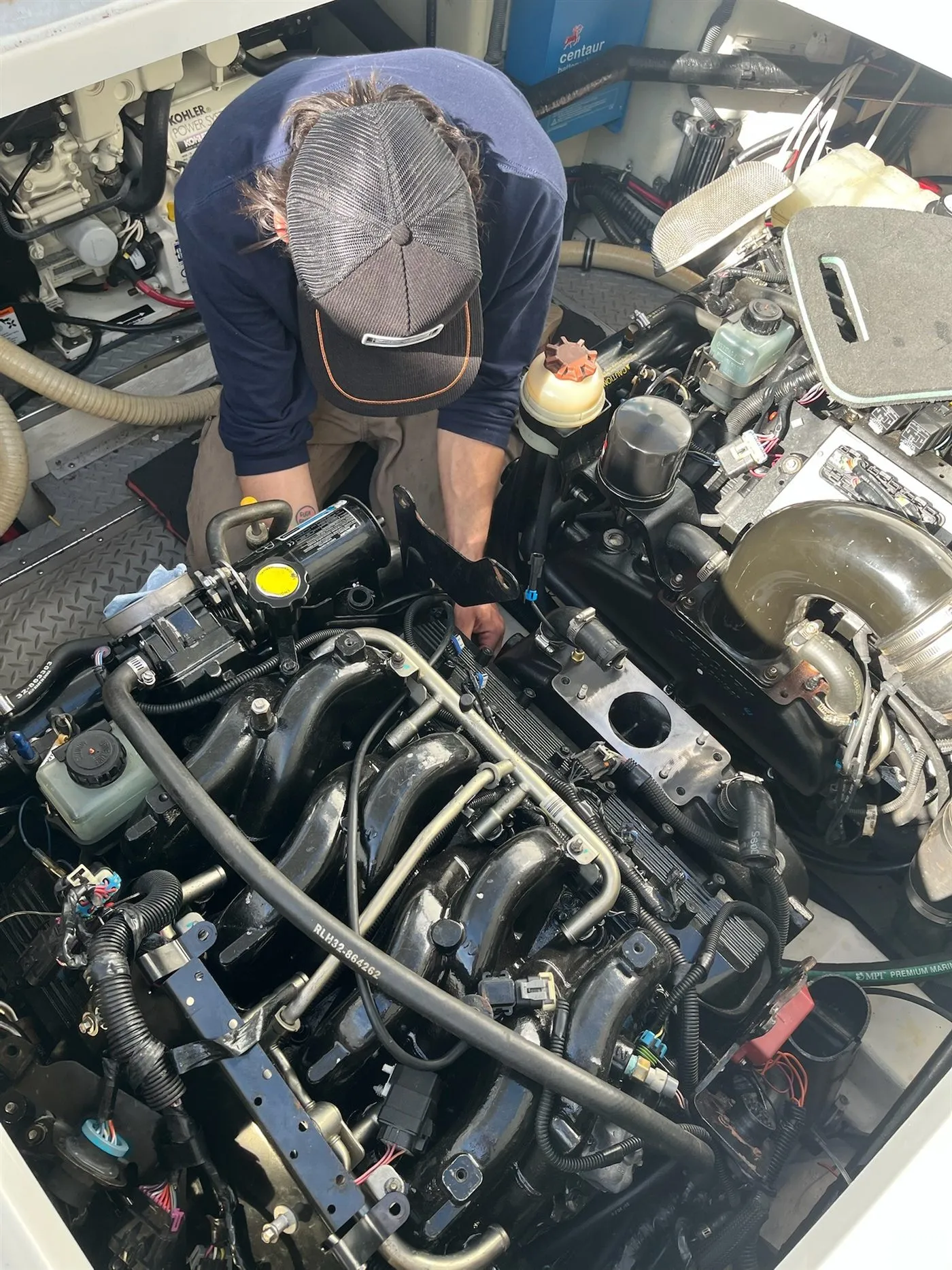 Technician servicing onboard generator and air-conditioning systems