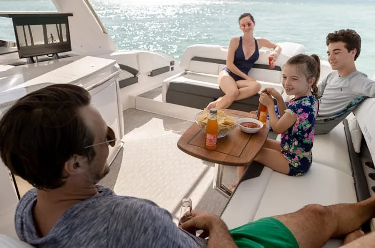 Family gathered around a cockpit table aboard a boat